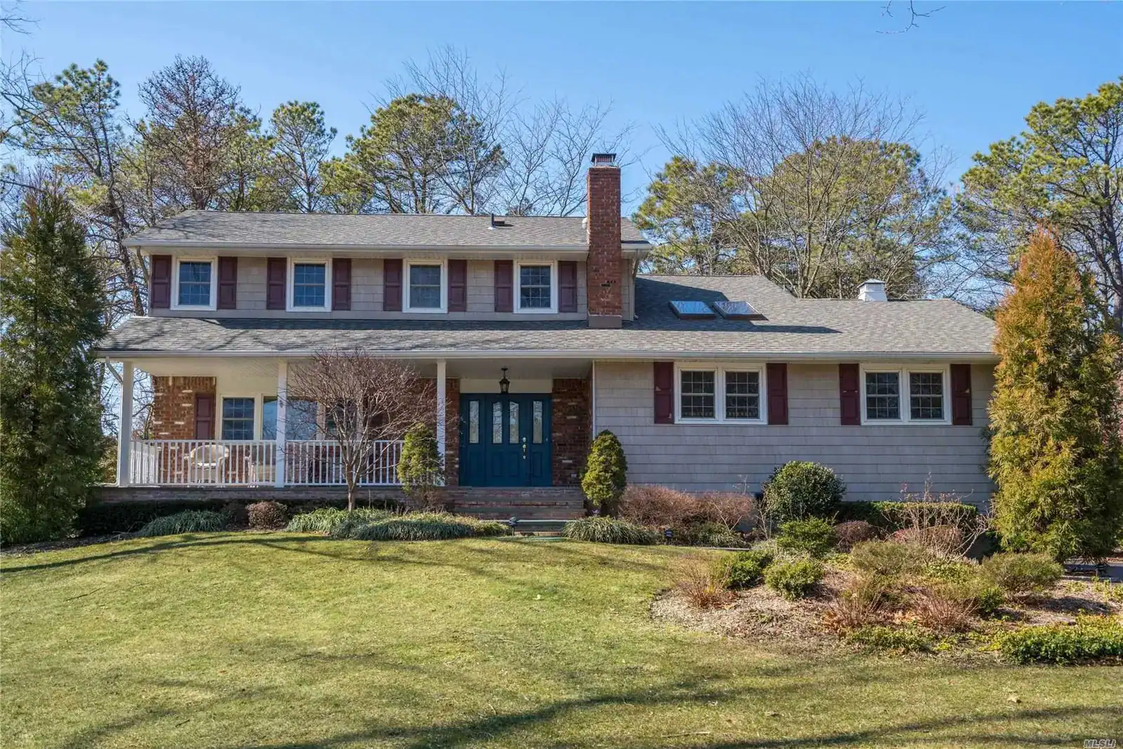 Spacious Long Island home with lush front yard and classic architecture.